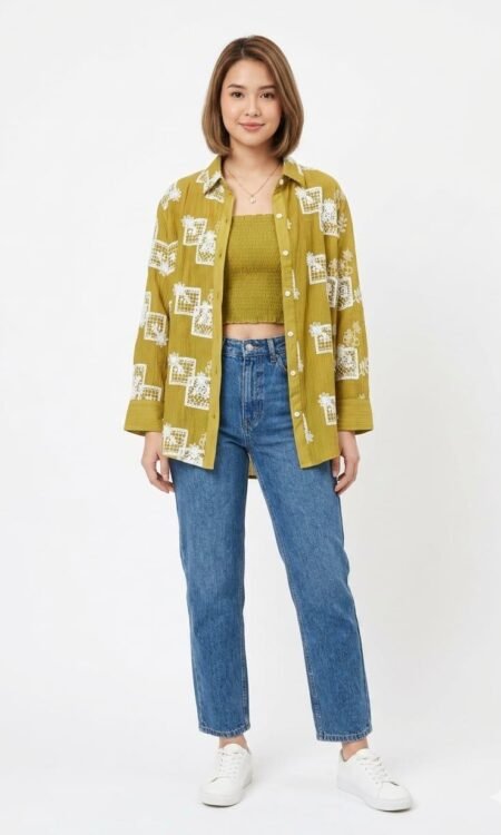 Embroidered Overshirt Artisanal Motifs: The long-sleeved overshirt is adorned with large, white block-style floral embroidery that creates a bold, graphic contrast against the olive base. Textured Fabric: Crafted from a lightweight, crinkled cotton-blend fabric, the shirt features subtle vertical ribbing for added tactile depth. Relaxed Fit: Designed with an oversized silhouette and a classic pointed collar, it can be styled open as a light jacket or buttoned up for a structured look.